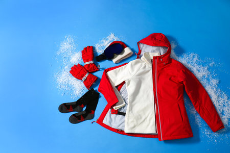 Stylish winter sport clothes on light blue background, flat layの写真素材