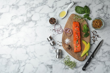 Delicious salmon with spinach and avocado served on white marble table, flat lay. Space for textの写真素材