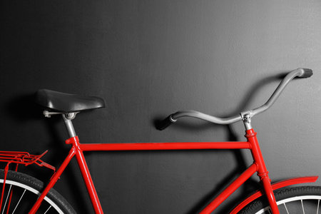 Red bicycle hanging on black wall, closeupの写真素材