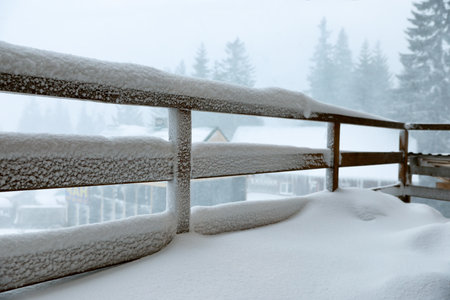 Cottage balcony covered with snow. winter beautyの写真素材