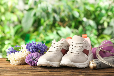 Composition with spring flowers and sports items on blurred green backgroundの写真素材