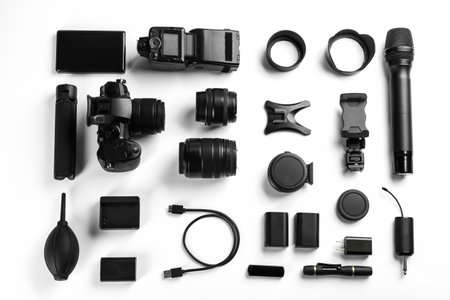 Composition with camera and video production equipment on white background, top view