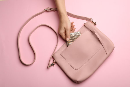 Woman with small bag on pink background, top viewの写真素材