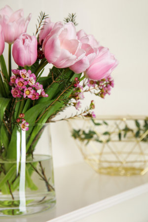 Beautiful bouquet with spring pink tulips on shelfの写真素材