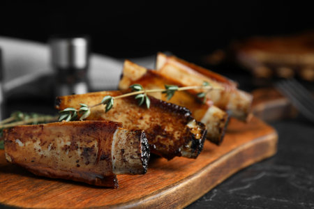 Delicious roasted ribs served on black tableの写真素材