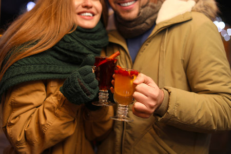 Happy couple with mulled wine at winter fair, closeupの写真素材