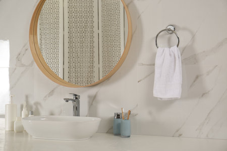 Bathroom interior with mirror, countertop and soft towel on wallの写真素材