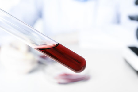 Test tube with blood sample on blurred background, closeup. virus researchの写真素材