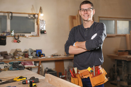 Professional carpenter with set of tools in workshopの写真素材
