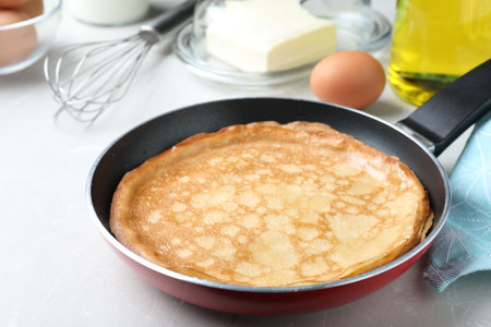 Delicious thin pancakes on gray marble table, closeupの写真素材