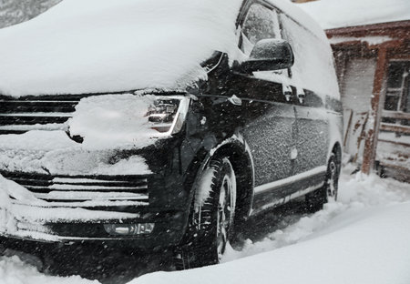 Modern car covered with snow outdoors on winter day, closeupの写真素材