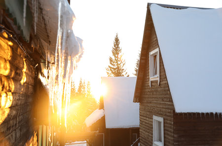Wooden houses covered with snow. winter holidaysの写真素材