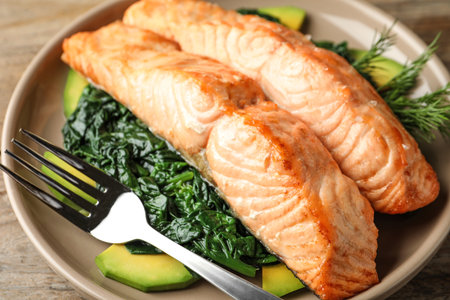 Tasty salmon with spinach and avocado on table, closeupの写真素材