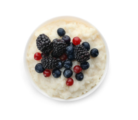 Delicious rice pudding with berries isolated on white, top viewの写真素材