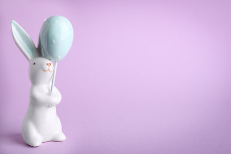 easter bunny figure on violet background. Space for textの写真素材