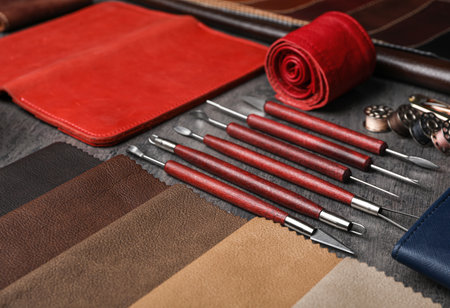 Leather samples and craftsman tools on gray stone backgroundの写真素材