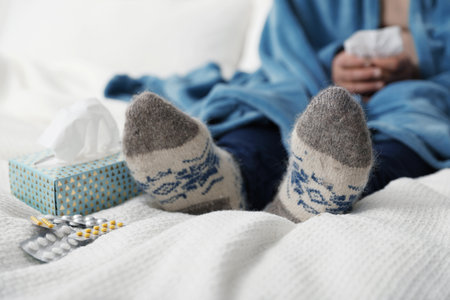 Mature man and cold remedies on bed, closeup. Dangerous virusの写真素材