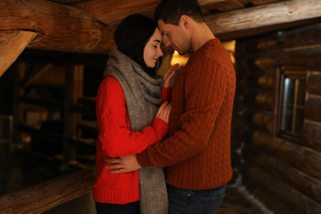 Lovely couple wearing warm sweaters indoors. winter seasonの写真素材