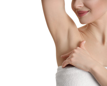 Young beautiful woman showing armpit with smooth clean skin on white background, closeupの写真素材