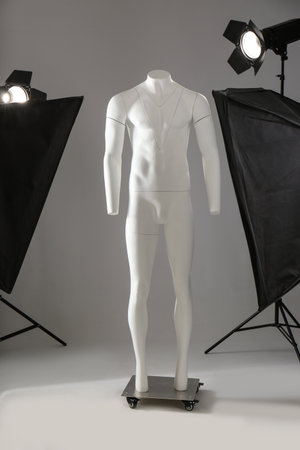 Ghost mannequin and professional lighting equipment in modern photo studioの写真素材