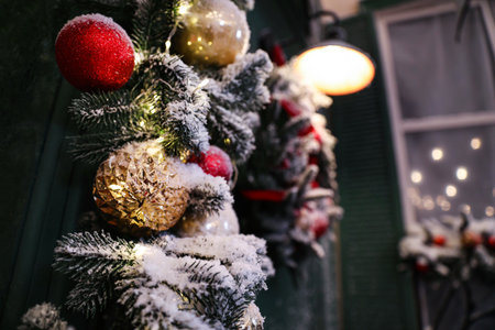 Beautiful decorative garland covered with snow outdoors, closeup. christmas celebrationの写真素材