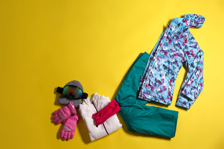 Stylish winter sport clothes on yellow background, flat layの写真素材
