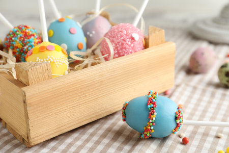 Delicious sweet cake pops in wooden crate on table, closeup. easter holidayの写真素材