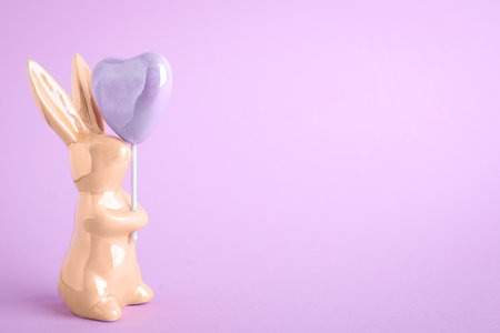 easter bunny figure on violet background. Space for textの写真素材