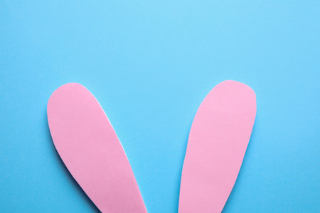 Top view of paper bunny ears on blue background. easter celebrationの写真素材