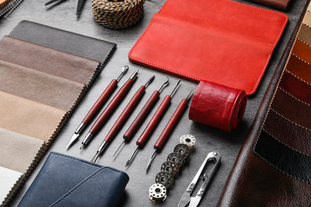 Leather samples and craftsman tools on gray stone backgroundの写真素材