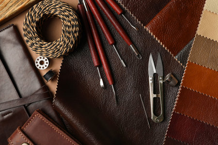 Flat lay composition with leather samples and tools on table
