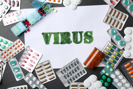 Paper with word VIRUS and many different pills on black background, flat layの写真素材