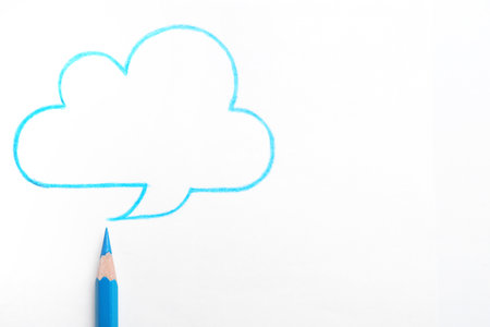 Drawing of cloud and light blue pencil on white background, top viewの写真素材