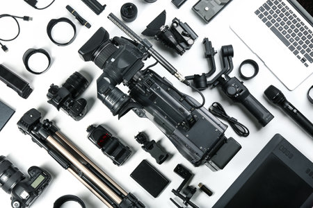 Flat lay composition with video camera and other equipment on white backgroundの写真素材