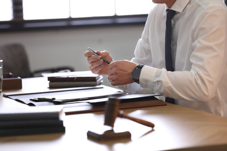 Male lawyer working at table in office, closeupの写真素材