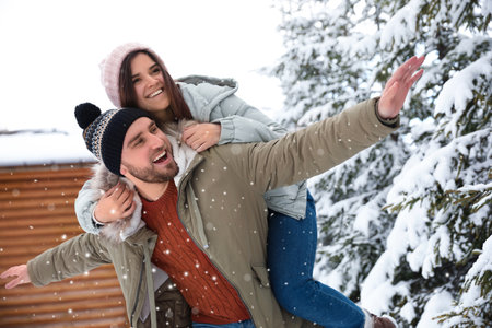 Lovely couple spending time together on snowy day. winter holidays