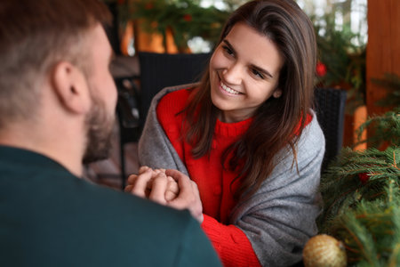 Romantic couple spending time together in cafe. winter holidaysの写真素材