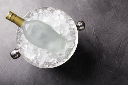 Bottle of vodka in metal bucket with ice on gray table, top viewの写真素材