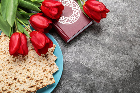 Flat lay composition with traditional Pesach (Passover Seder) matzo on gray table. Space for textの写真素材