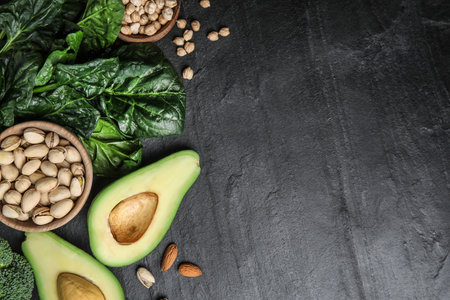 Different products rich in vitamin E on dark background, flat lay. Space for textの写真素材