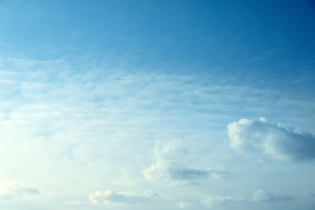 Beautiful light blue sky with fluffy cloudsの写真素材
