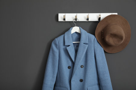 Coat and hat on wall hanger in stylish hallway interiorの写真素材