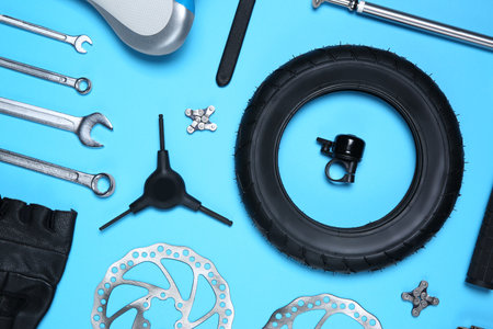 Set of different bicycle tools and parts on light blue background, flat layの写真素材