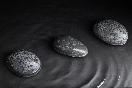 Stones in water on gray background. Zen lifestyleの写真素材