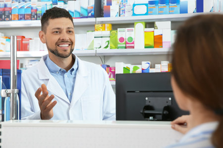 Professional pharmacist working with customer in drugstoreの写真素材