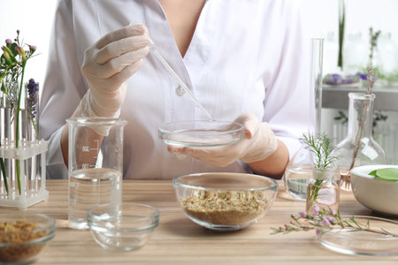 Scientist developing cosmetic product in laboratory, closeup