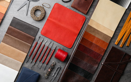 Flat lay composition with leather samples and craftsman tools on gray stone background