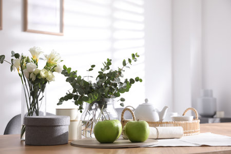 Apples and tea set on wooden table indoors. Stylish interior designの写真素材