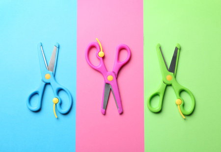Bright scissors on color background, flat layの写真素材