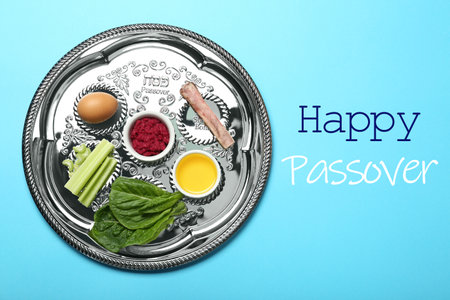 Passover Seder plate (keara) with symbolic meal on light blue background, top view. Pesah celebrationの写真素材